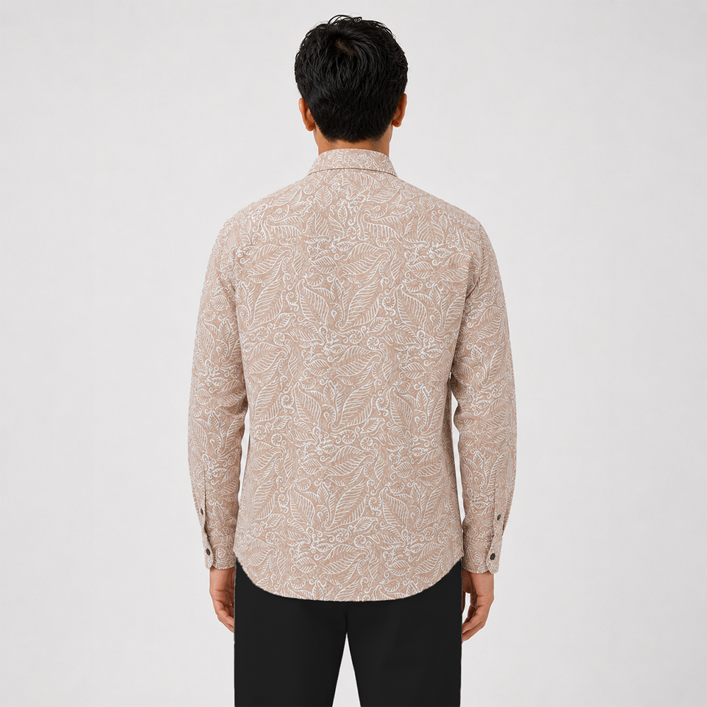 Man wearing a beige patterned shirt on a white background