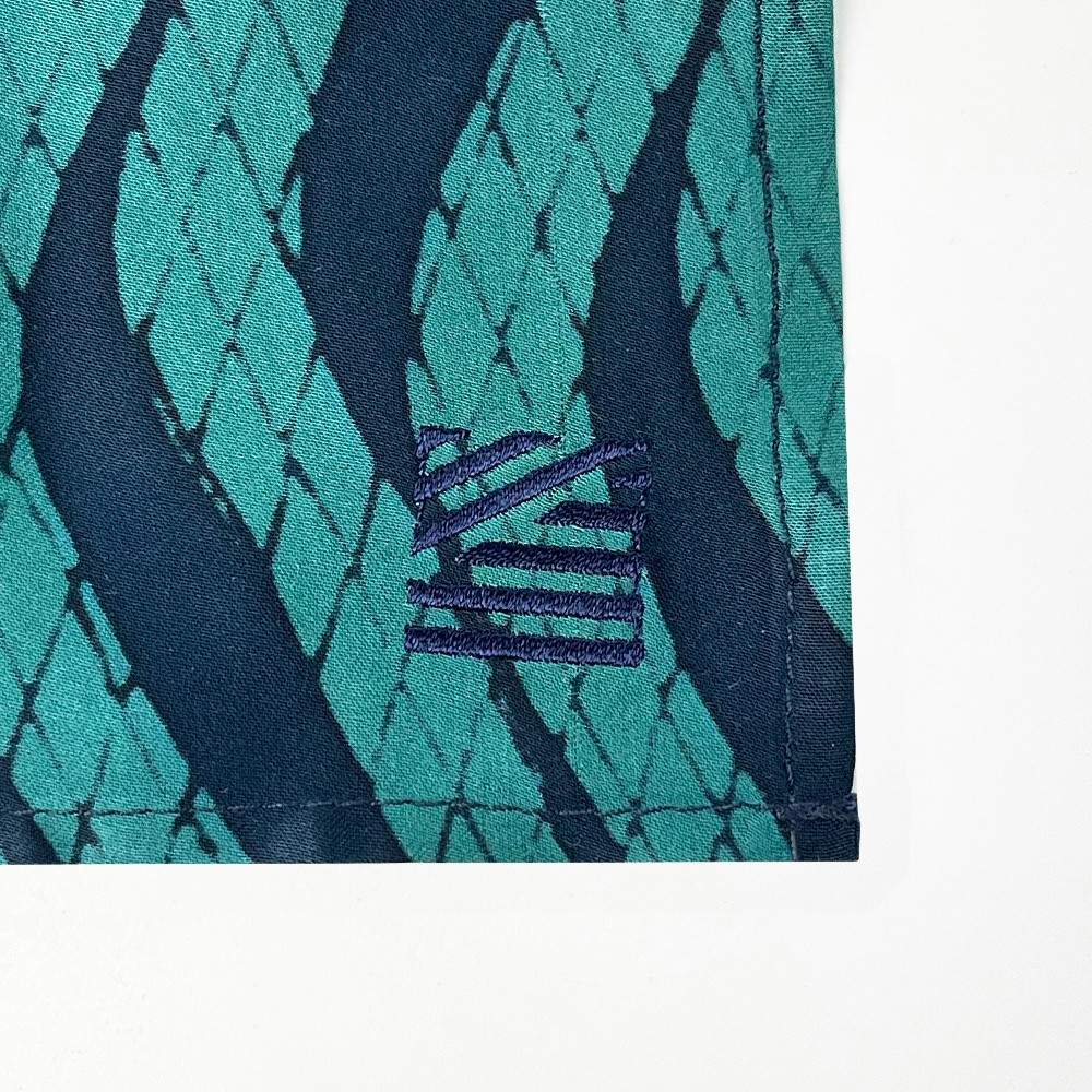 Batik Neck Tie & Pocket Square (Silk Cotton) - Teal Snakeskin shown with the Batik boutique embroidery design 