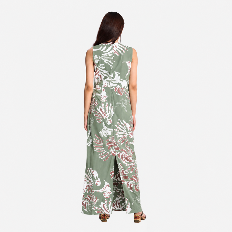 Lady facing the back wearing green printed batik dress