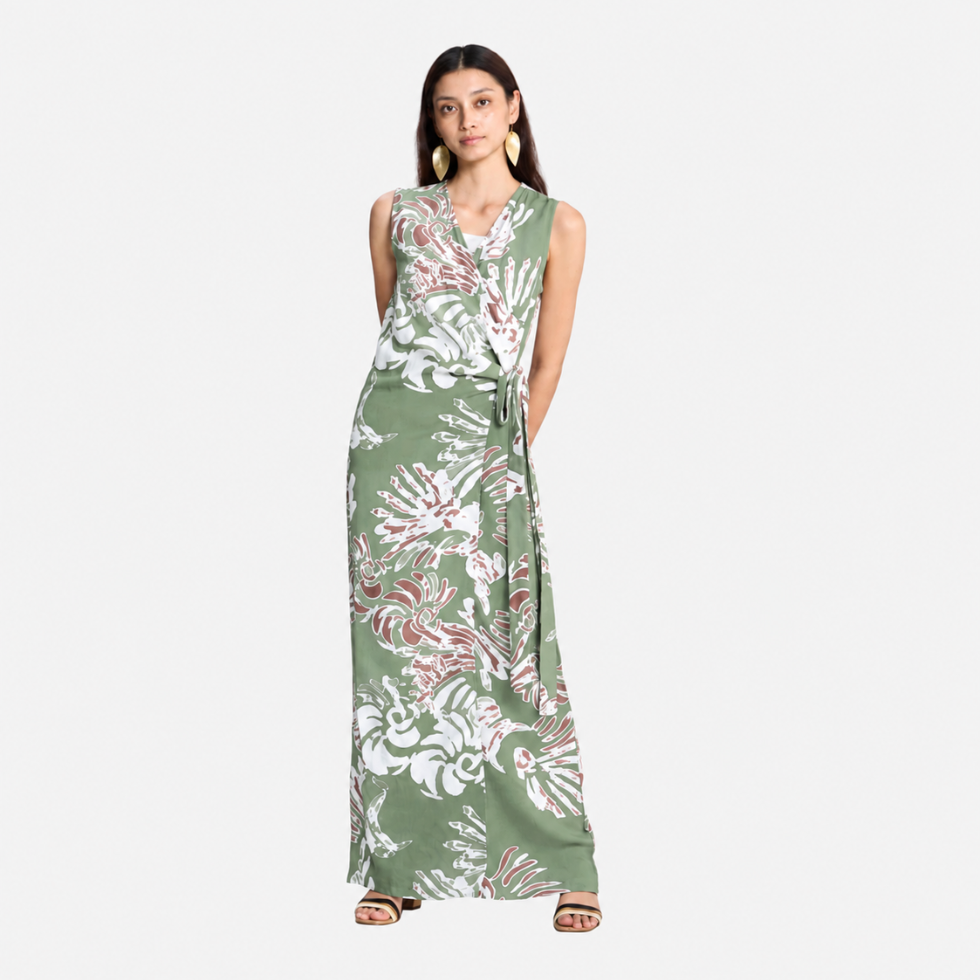 Girl wearing green printed batik dress facing the front