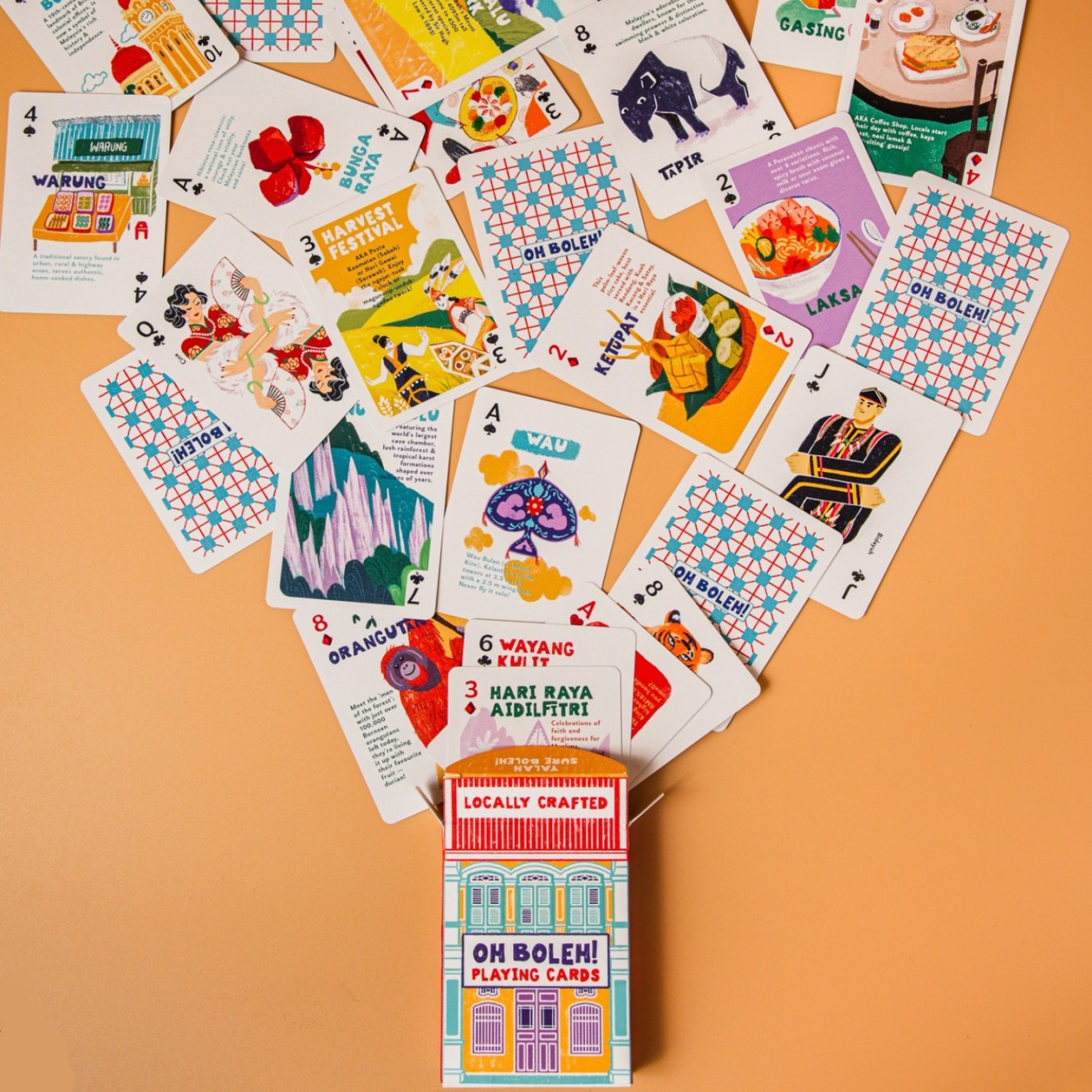 Collection of playing cards with colorful designs on a beige background, featuring the 'Locally Crafted' brand.
