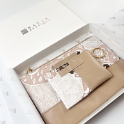 Set of beige pouches with intricate patterns in a box labeled 'Batik Boutique'.