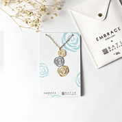 Necklace with rose-shaped pendants on a branded card with 'Embrace Batik Boutique' branding.