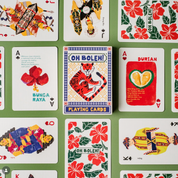Collection of playing cards with colorful designs on a green background