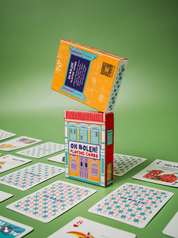 Playing cards with 'Oh Boleh!' branding on a green surface