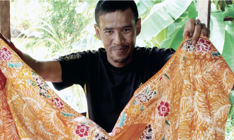 Local artisans creating handcrafted batik using traditional techniques passed down through generations.