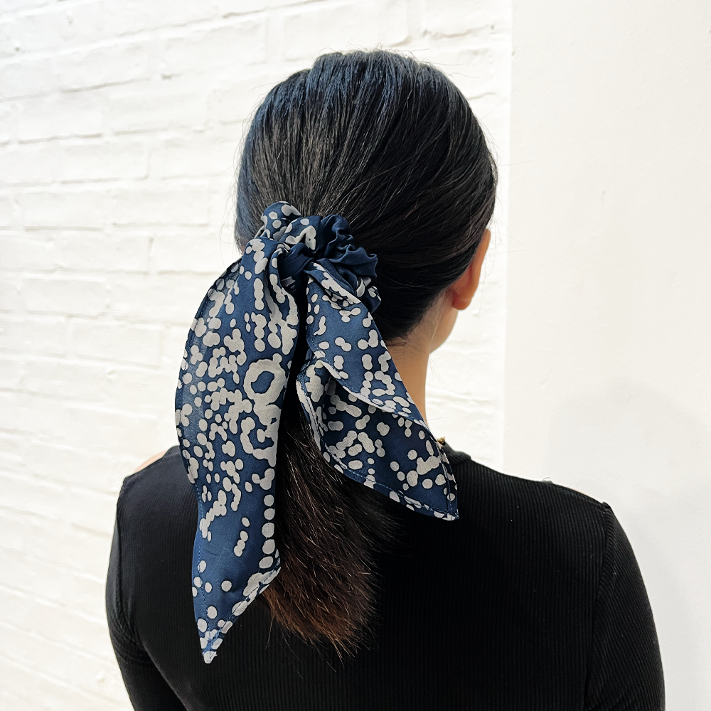 Navy orchid scrunchie being shown worn by a women 