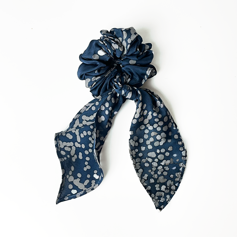 White box photo of the navy orchid scrunchie 