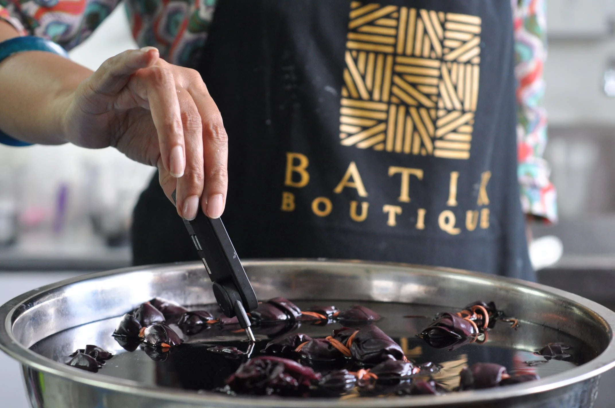 Skilled artisans creating authentic batik designs using traditional techniques.