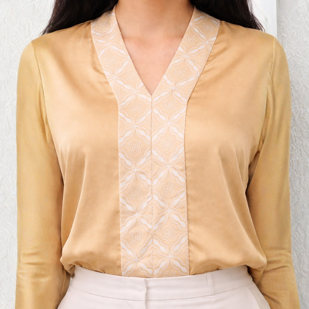 Beige blouse with white geometric pattern on a plain background