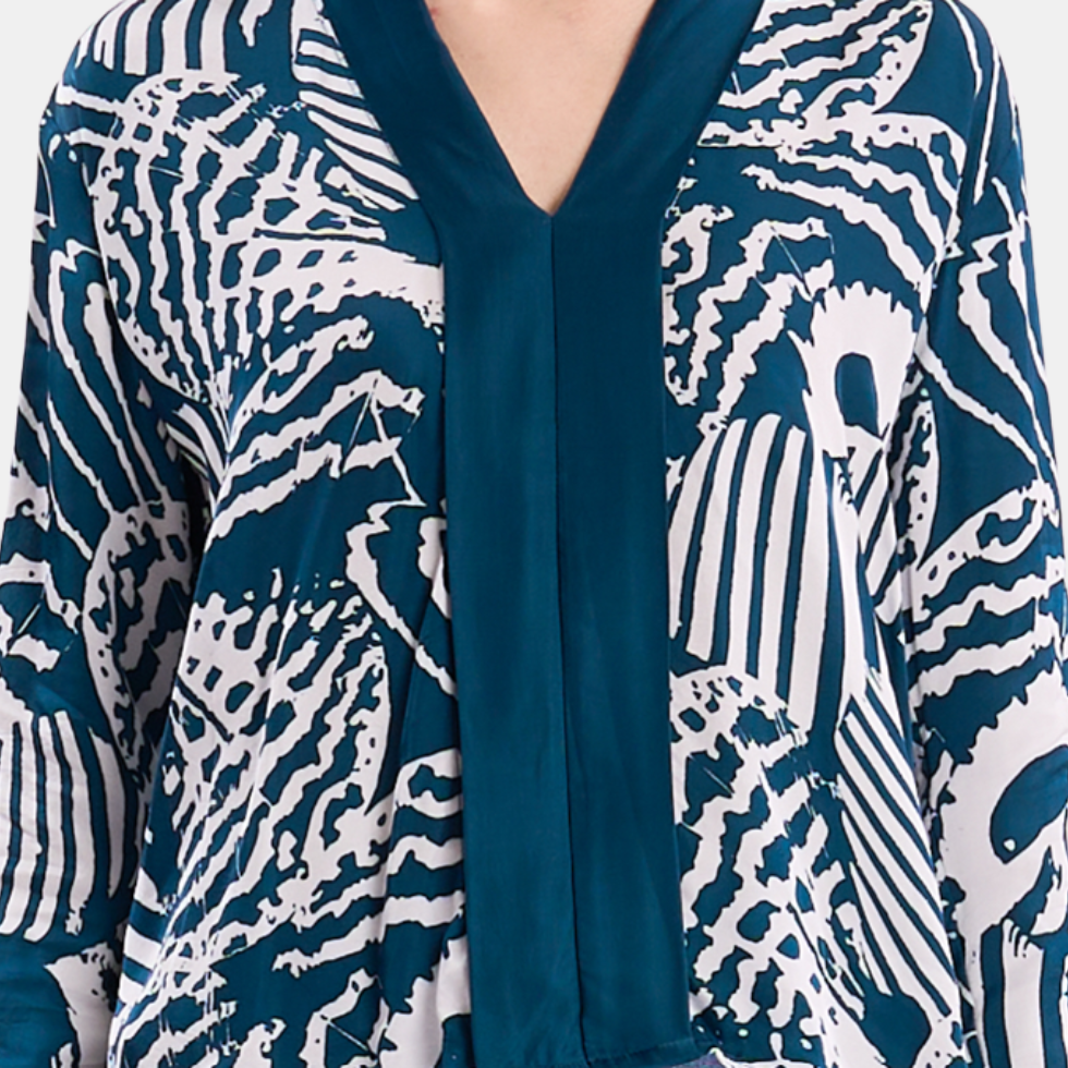Closeup up of a woman wearing blue printed batik kebaya top