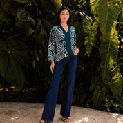 Woman wearing a Blue Printed Kebaya Top standing outdoors with trees