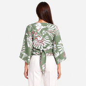 Woman facing the back wearing green tie front kimono