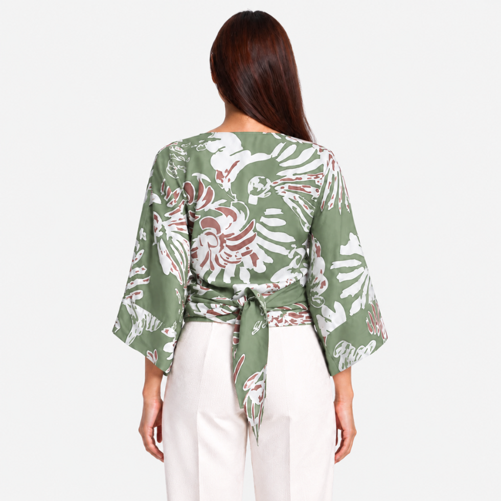 Woman facing the back wearing green tie front kimono