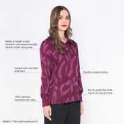 a woman posing against a white background in plum rimba shirt