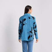 Back facing photo of the azure blooming lace shirt showing of the white lattice design framing the black florals design 