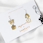 Gold earrings on a branded card with 'Embrace Jewellery' and 'The Job or Salt' branding.