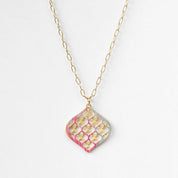 Necklace with a geometric pendant on a white background