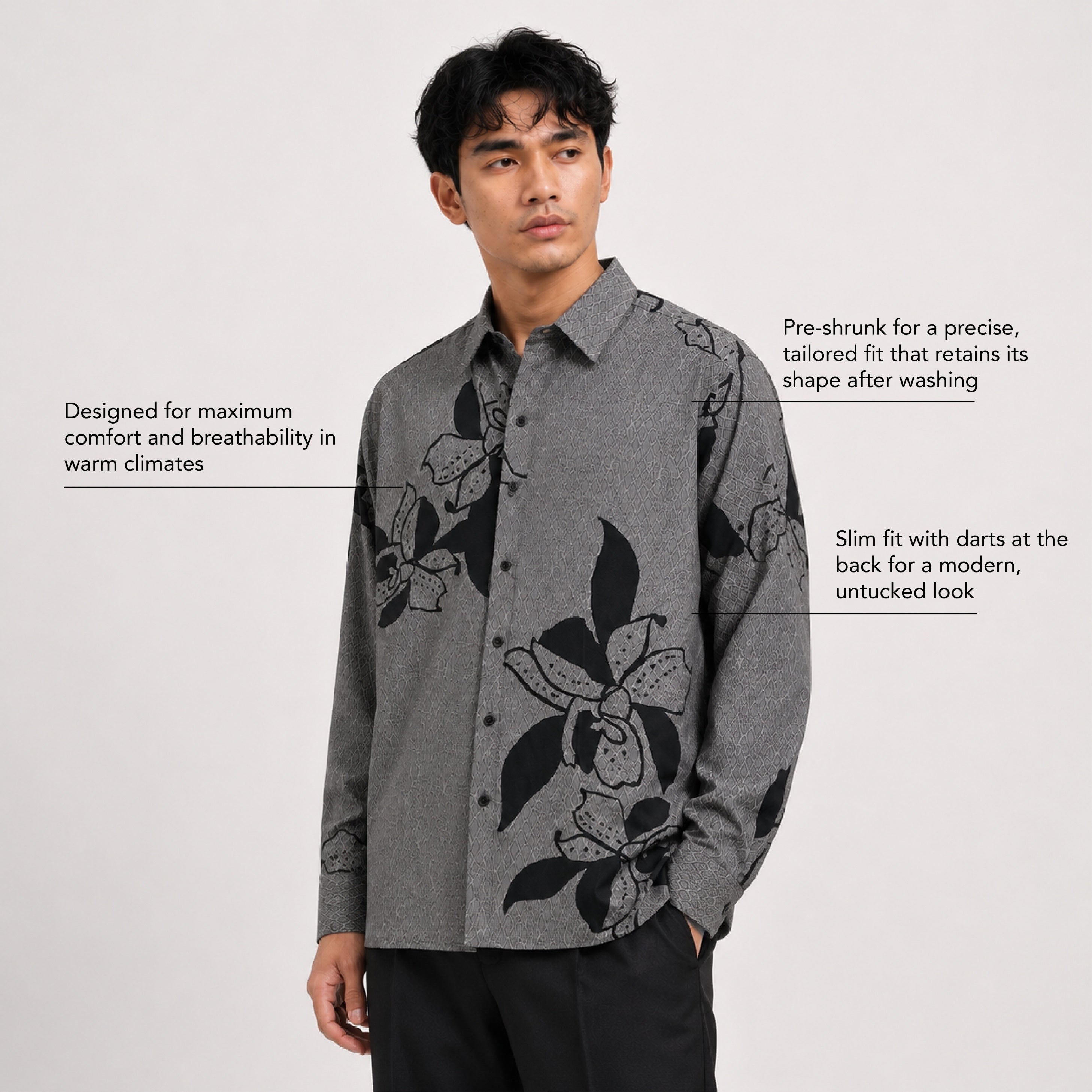Man wearing a gray floral shirt on a white background